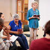 People Attending Bible Study Or Book Group Meeting In Community Center