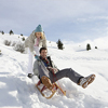 Young couple sledding