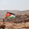 The flag of Jordan blowing in the wind in Petra, Jordan