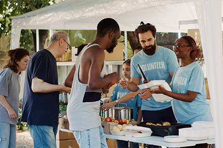 Volunteer team graciously providing warm meals