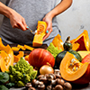 Woman prepare squash for cooking pumpkin dish. Close-up.