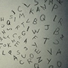 woman speaking - letters on wall