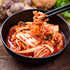  Eating kimchi cabbage in a bowl with chopsticks, Korean food
