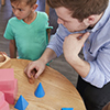 teacher with young kids at table