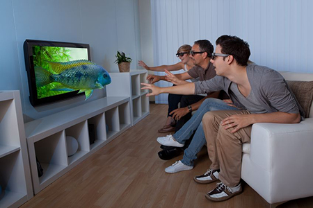 Conceptual image of a family watching 3D television and stretching out their hands as though to touc