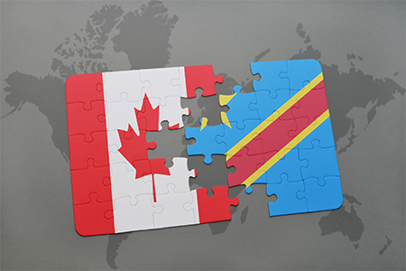 puzzle with the national flag of canada and democratic republic of the congo on a world map backgrou