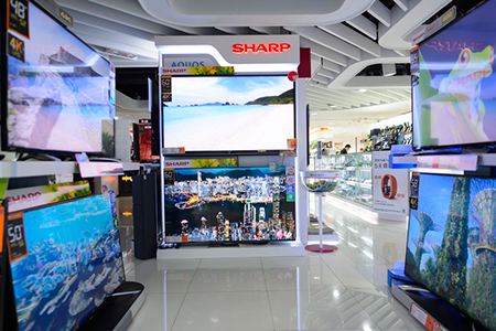 interior of electronic store with TV displays