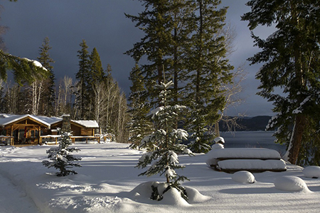 British Columbia Scenery Canim Lake Canada Winter - Cottage and trees covered in snow