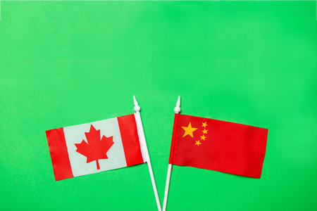 canada and china flags on green background