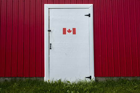 Red building exterior with white door - canada flag printed on door