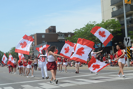 Canada day parade - people holding large flags