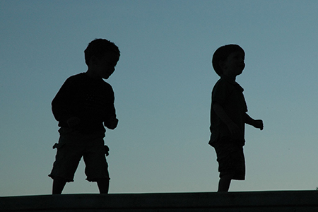 silhouettes of two boys 
