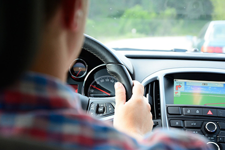 over-the-shoulder shot of driver with navigation displayed