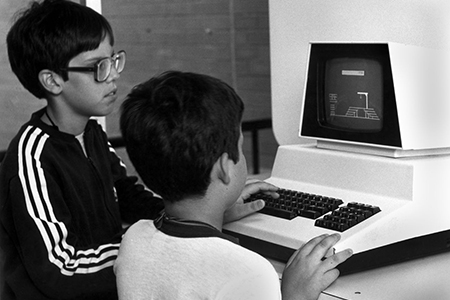 two boys playing game on Commodore PET personal computer 1983