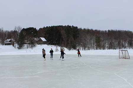 Teens skating on frozen lake