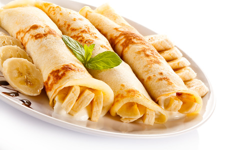 Crepes with bananas and cream on white background (banana)