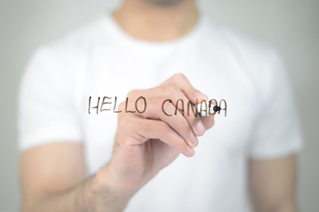 Hello Canada, man writing on transparent screen