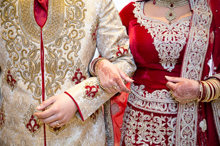 Asian bride and groom arm in arm (indian, wedding, couple)