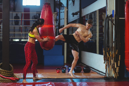 Boxer practicing a kick boxing in fitness studio