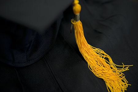 mortarboard cap with yellow tassel close up