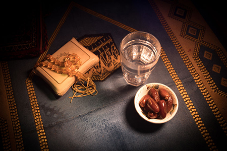 Islamic prayer rug with dates and water