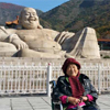 Xue’s mother in front of a Good Fortune Buddha 
