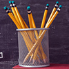 back to school written on chalkboard - pencils and apple on desk