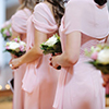 Row of bridesmaids with bouquets at wedding ceremony