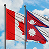 Canada and Nepal flag waving in the wind against white cloudy blue sky together. Diplomacy concept, 