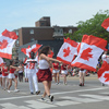 Canada day parade - people holding large flags