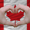 canada flag with hands forming heart over top