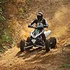 ATV rider with helmet and full gear riding downhill