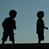 silhouettes of two boys 