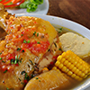 view of soup bowl with chicken, corn and other mixed vegetables