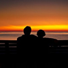couple watching the sunset over the ocean