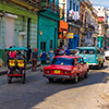 People and old cars in a central street in Havana