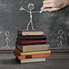 chalkboard sketch of person standing above all on a stack of books