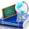 english dictionary with globe and learn english written on small chalkboard