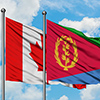Canada and Eritrea flag waving in the wind against white cloudy blue sky together. Diplomacy concept