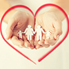family holding hand - paper cutout encircled with heart