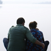 Family of 4 huddled together on dock