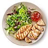 Green salad and grilled chicken fillet on plate isolated on white background, top view