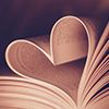 Open book with pages folded into heart