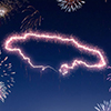 A dark night sky with a sparkling red firecracker in the shape of Jamaica composed into