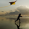 Boy with Kite at sunset on the beach