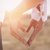 bride and groom's hands forming heart