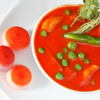 Matar Paneer (Peas and Cheese) in red tomato sauce in white plate