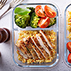 Healthy meal prep containers with chicken, rice and vegetables