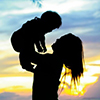 silhouette of mother holding baby 