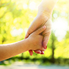 Hands of mother and daughter holding each other